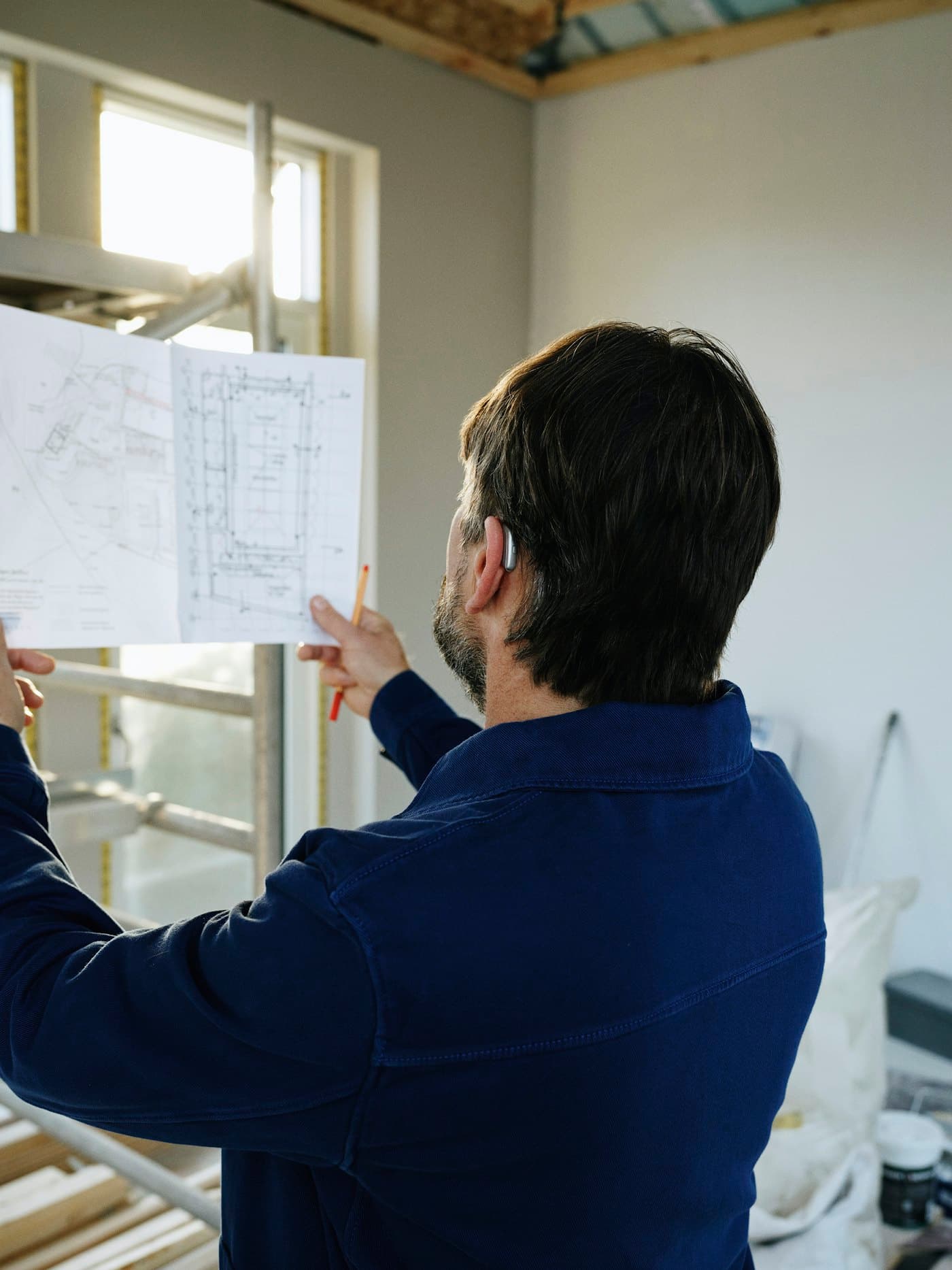 Team member reviewing renovation drawings