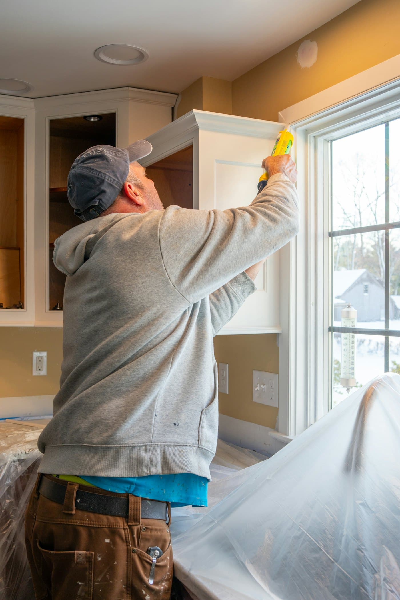 Handyman repairing a window frame