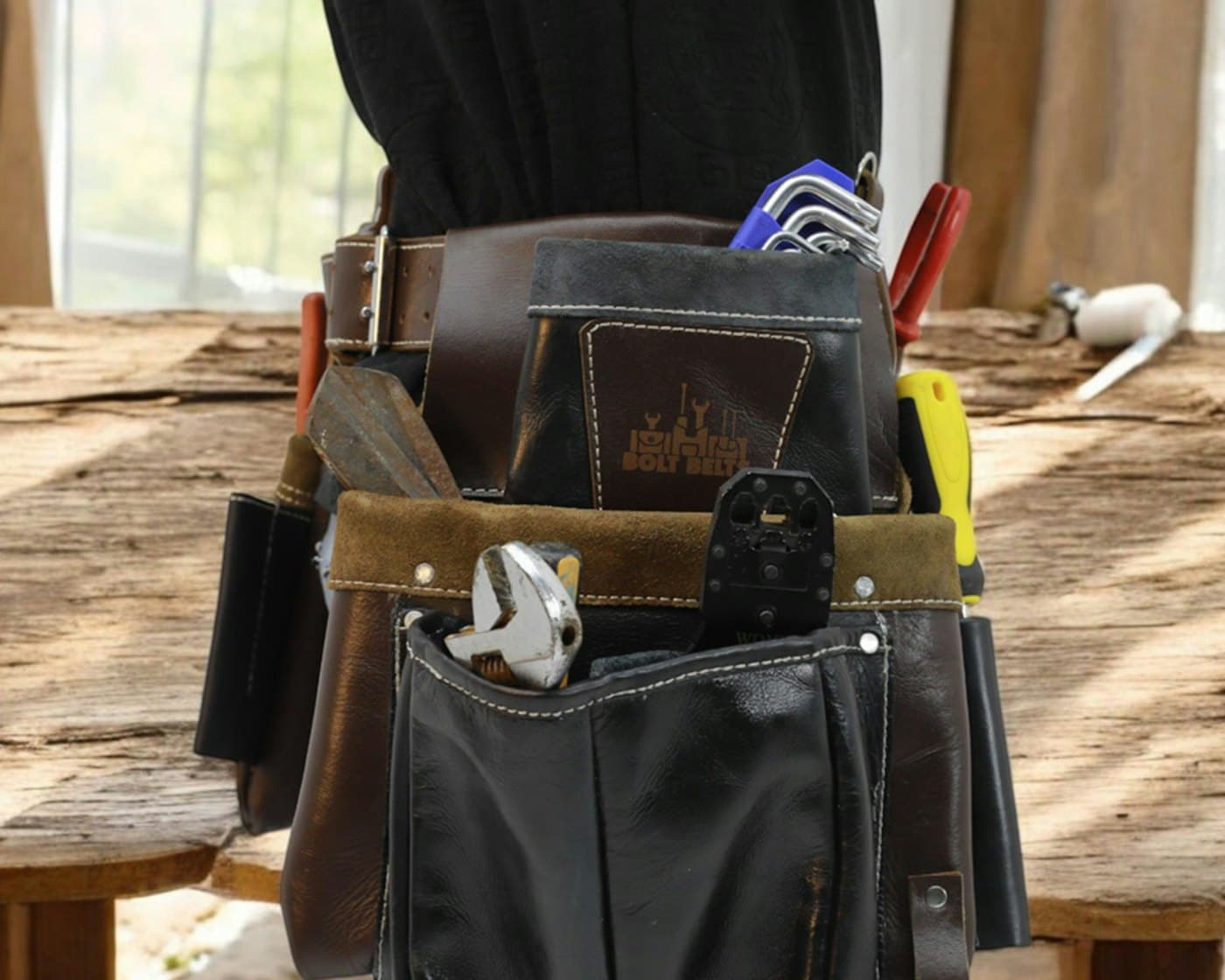 Tool belt with hand tools on a workbench