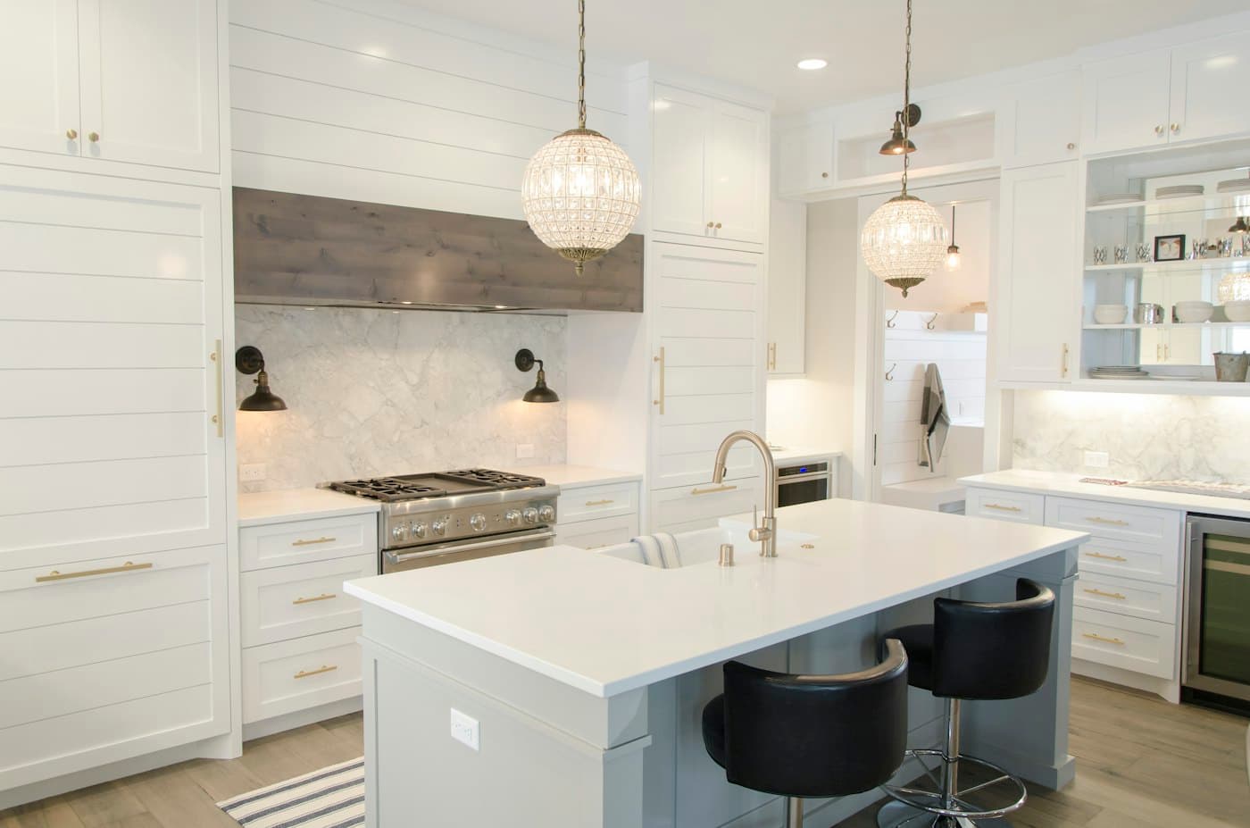 Bright kitchen with marble island and pendant lights